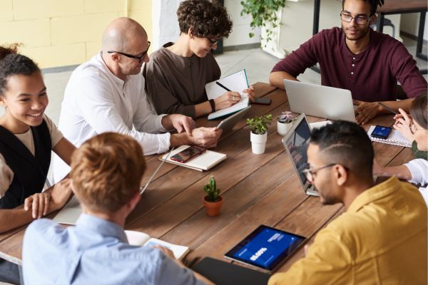 Malaysian employees working collaboratively in a hybrid office setting
