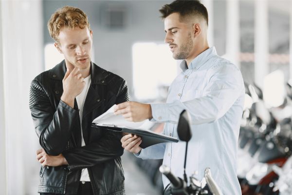 Corporate trainer consulting with client about customized training modules.