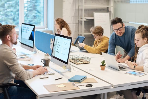 Employees learning programming in a workshop.