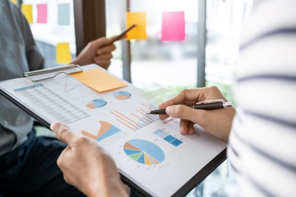 Business team reviewing employee performance statistics