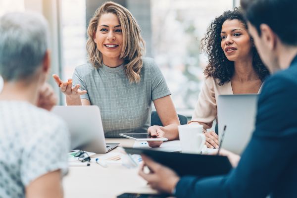 Manager mentoring employee in a one-on-one meeting.
